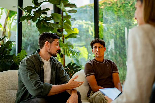 istock Father and son talking to psychotherapist during psychotherapy session 2237195027