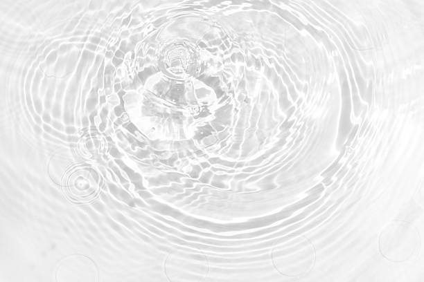 istock White water with ripples on the surface. Defocus blurred transparent white colored clear calm water surface texture with splashes and bubbles. Water waves with shining pattern texture background. 2237198245