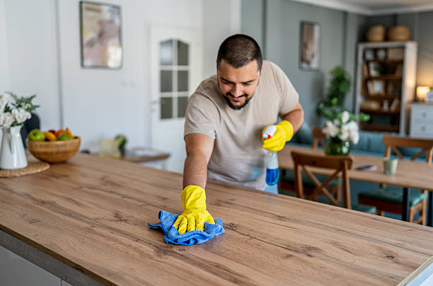 istock Man cleaning kitchen countertop at home 2237201728