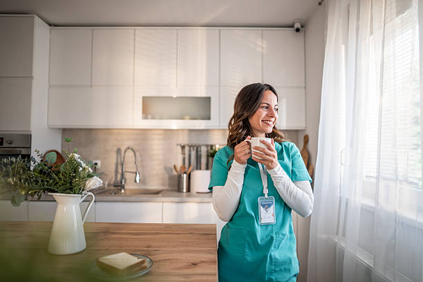 istock Nurse enjoying coffee break by window in kitchen 2237201808