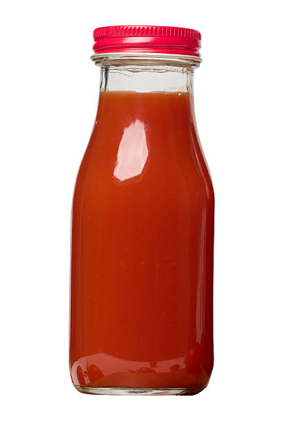 istock Glass bottles with tomato juice with red caps. 2237202543