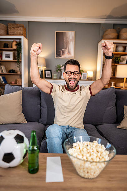 istock Excited man watching soccer match at home 2237202645