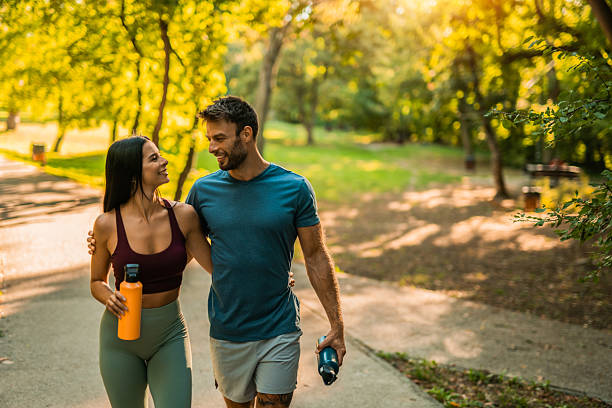 istock Happy athletic couple walking through the park. 2237204393