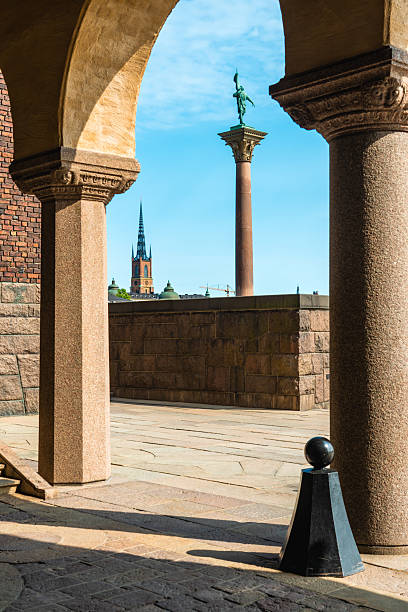 Stockholm city hall architecture featuring arches, columns, and staircase in sunlight