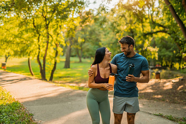 istock Happy athletic couple walking through the park. 2237204921