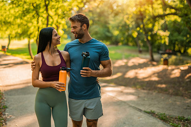 istock Happy athletic couple walking through the park. 2237204945