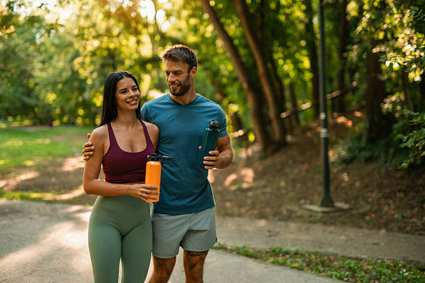 istock Happy athletic couple walking through the park. 2237204974