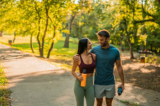 istock Happy athletic couple walking through the park. 2237205280
