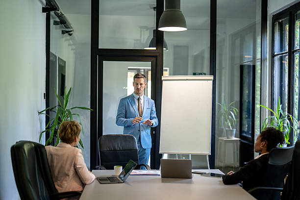 istock Businessman leading a presentation to colleagues in modern office 2237211475