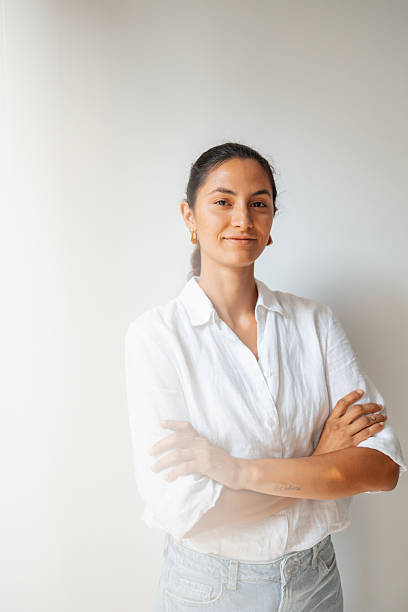 istock Confident woman in a casual outfit standing against a plain background 2237212415