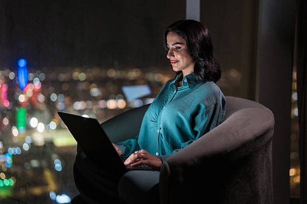 istock Arabic Female Working on Laptop with Riyadh Skyline 2237212587
