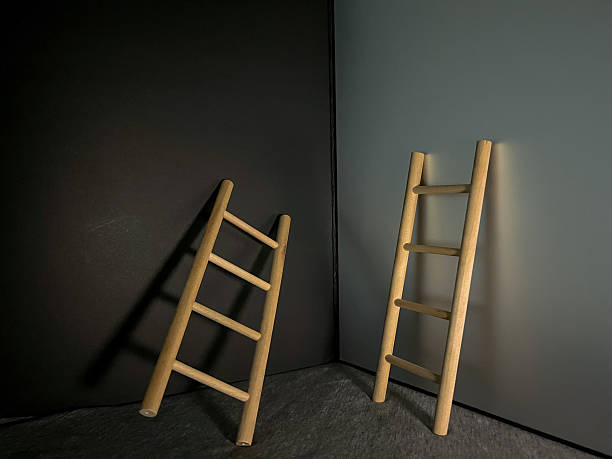istock Two wooden ladders leaning on different backgrounds 2237216251