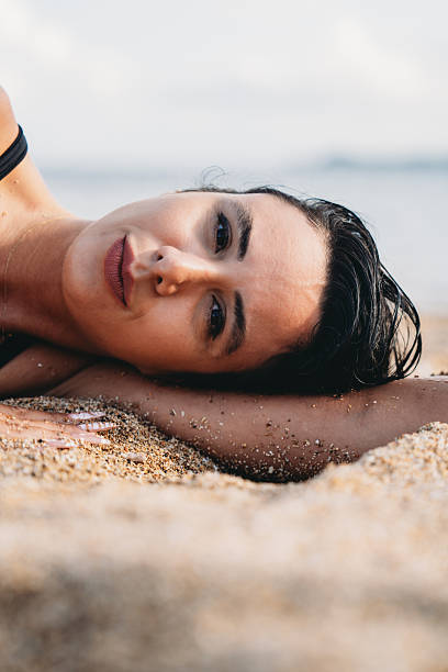 istock Woman relaxing on sandy beach during vacation 2237219728