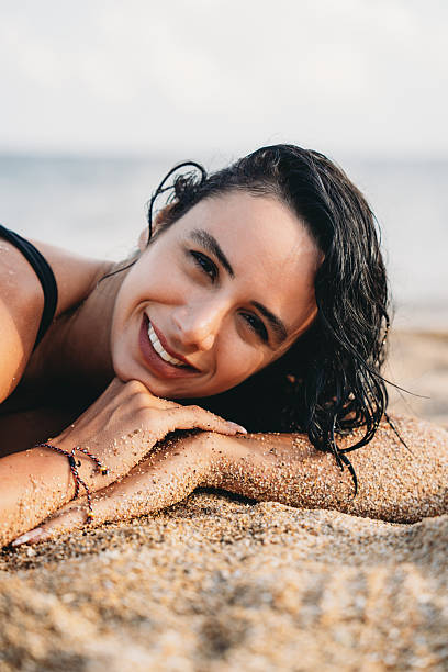 istock Happy woman relaxing on beach during summer vacation 2237219756