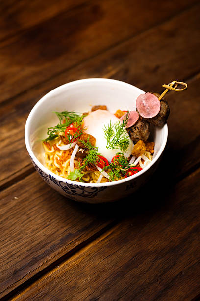 Studio Shot of Noodle Bowl with a Soft-Boiled Egg and Meat Skewer Street Food