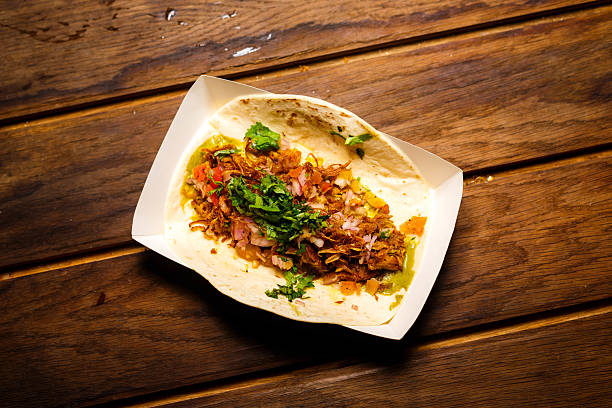 Overhead View of a Taco with Shredded Meat and Salsa On Paper Take Out Tray