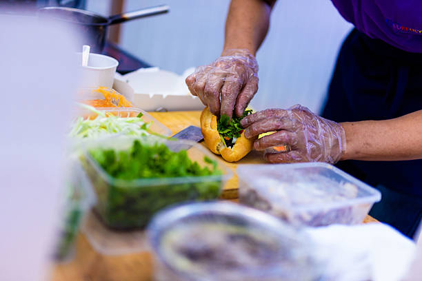 istock Gloved Hands Preparing a Sandwich at a Food Stall 2237221239