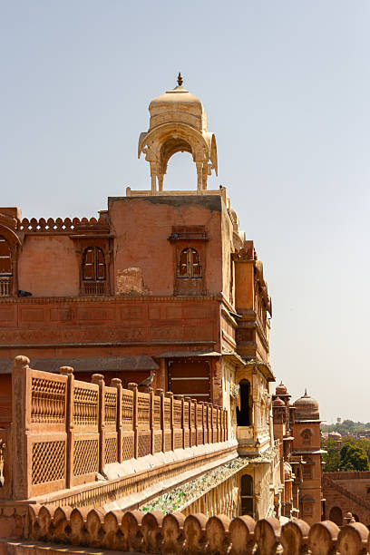 istock Terracotta Sandstone Balconies, Ornate Railings, and a Light-Colored Domed Chatri Tower 2237231429