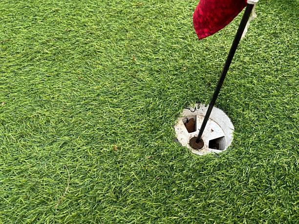 istock Golf hole with red flag on green grass 2237232216