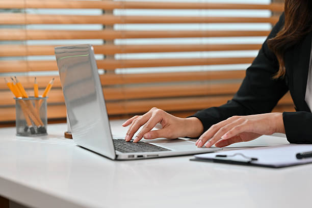 istock Remote work concept featuring a businesswoman using a laptop with copy space, Close-up image 2237232648