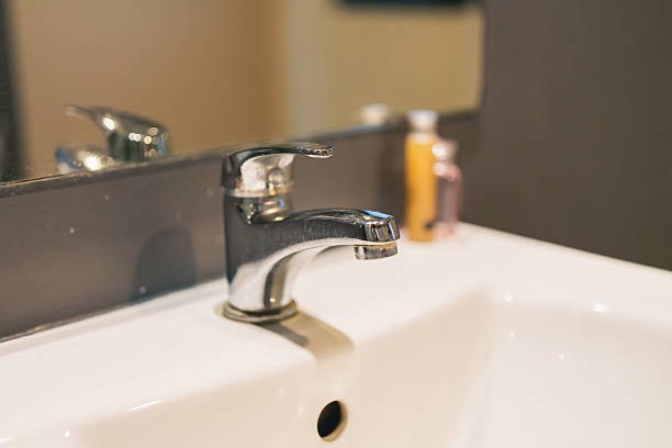 istock Modern Chrome Faucet with a White Sink and Soap Dispenser in a Minimalist Bathroom Setting for Interior Design Inspiration and Home Decor Ideas 2237234678