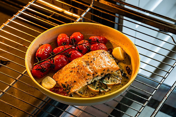 Roasted salmon steak with cherry tomatoes on oven rack