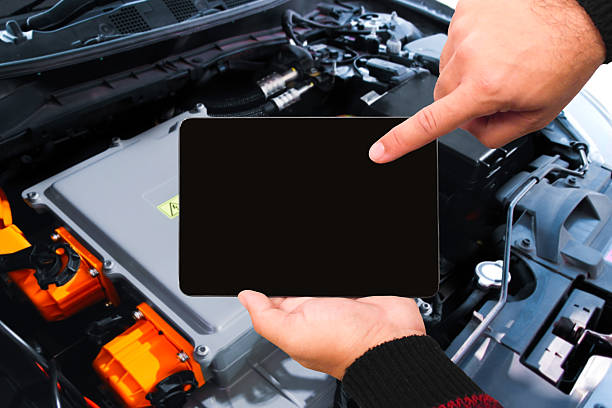 istock Mechanic using digital tablet with black blank screen to inspect hybrid or electric vehicle battery system 2237243309