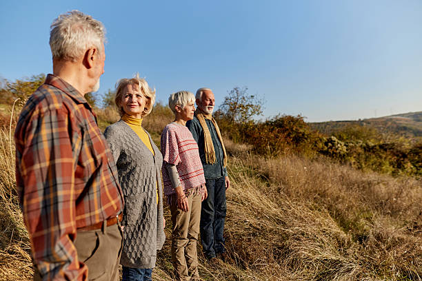 istock Mature friends looking at view from a hill. 2237247523