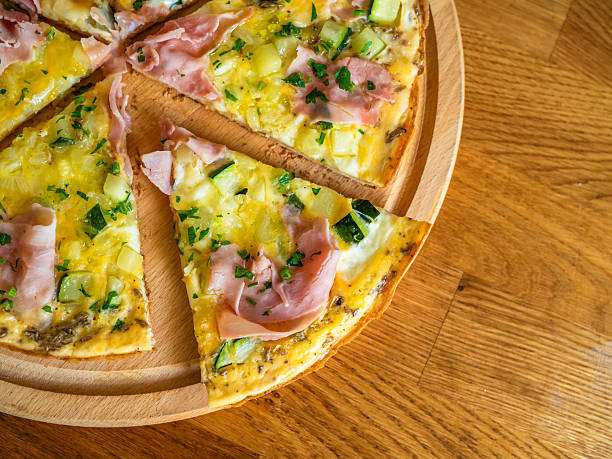 istock Frittata - scrambled eggs with cheese, ham and vegetables on wooden table 2237249201