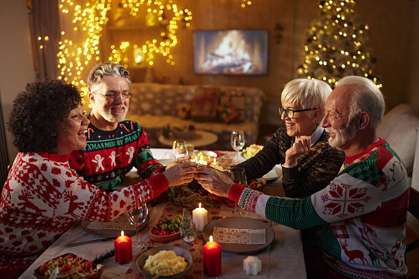 istock Happy senior couples toasting on Christmas lunch in dining room. 2237249516