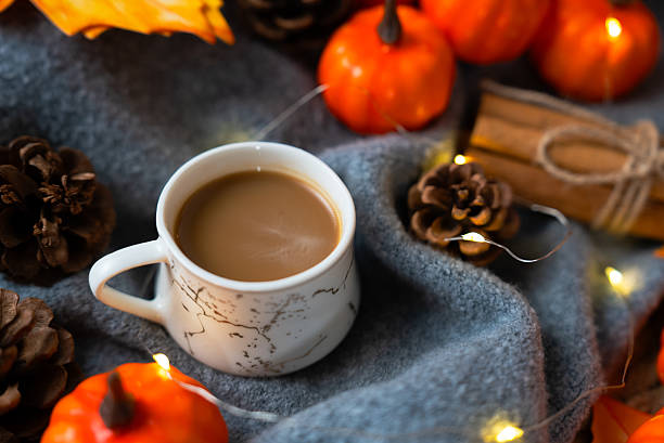 istock Cozy cup on blue blanket with pumpkins and lights 2237252035