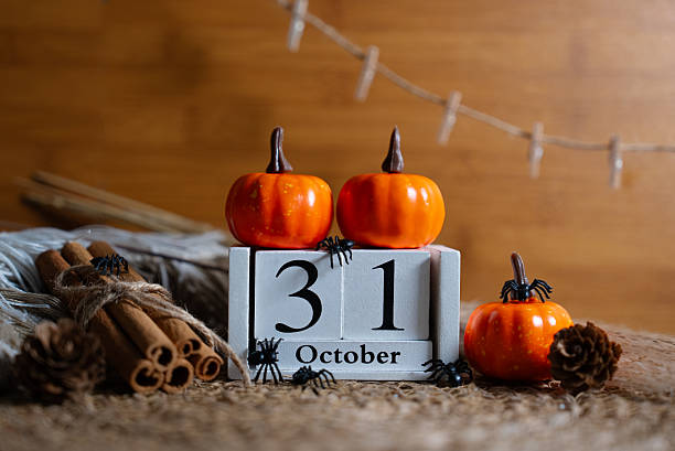 istock Pumpkins and October 31 block with rustic autumn background 2237252105