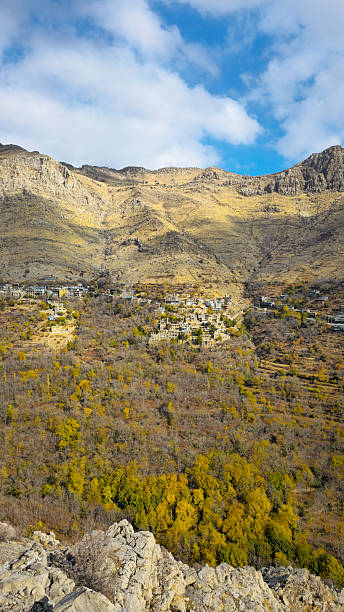 istock Autumn valley with hillside village 2237252340
