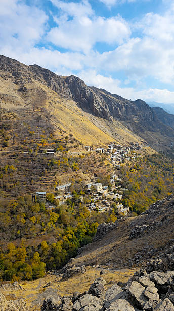 istock Forested autumn valley with village 2237252359