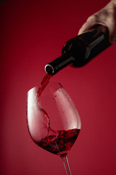 istock Pouring red wine from a bottle into a glass. 2237255171