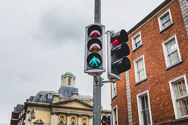 Dublin, Ireland - September 22, 2018: Pedestrians wait for the green light at a busy intersection in Dublin.