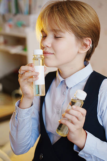 istock Child enjoying aroma diffuser liquid in cozy indoor setting 2237259466