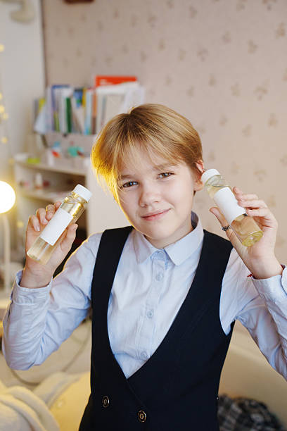 istock Child holding aroma diffuser liquids in a cozy home setting 2237259891
