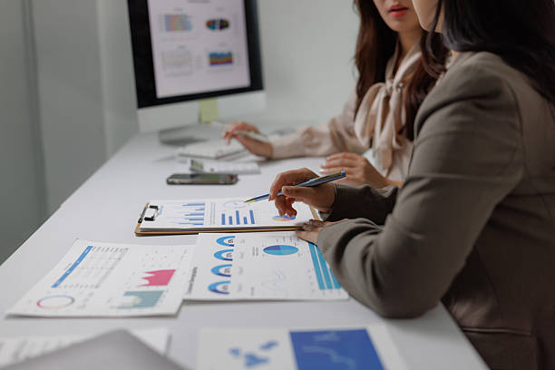 istock Business women analyzing financial data charts in modern office 2237261640