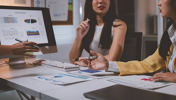 istock Businesswomen analyzing financial data report in office meeting 2237262468