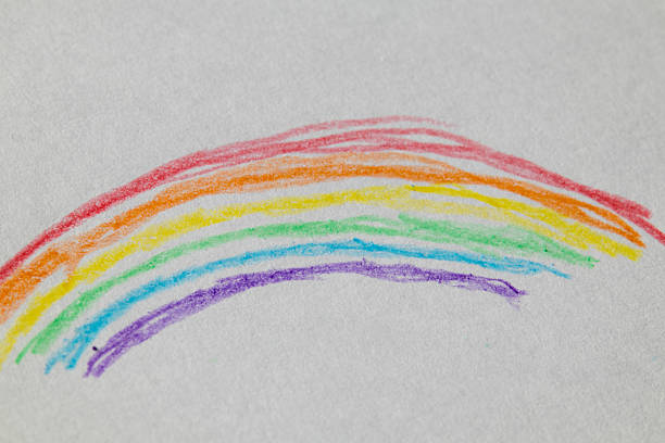 istock Colorful hand-drawn rainbow on white paper using crayons. Simple and cheerful child art concept 2237262995