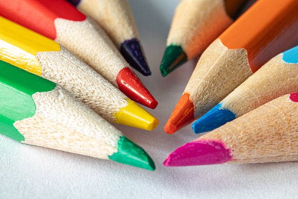 istock Close-up of sharpened colored pencils arranged in a radial pattern. Bright rainbow colors on white background. Macro composition 2237263015