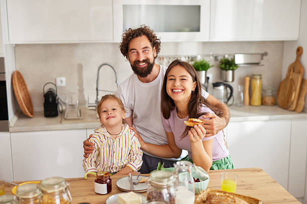 istock Happy family enjoying breakfast together in modern kitchen 2237263400