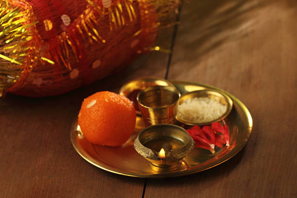A decorated Navratri puja thali with diya, sweets, rice, flowers, and essential items used in Hindu festive rituals.