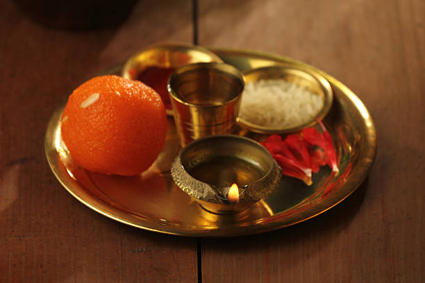 A decorated Navratri puja thali with diya, sweets, rice, flowers, and essential items used in Hindu festive rituals.