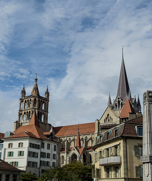 A large church with a steeple and a large window. The building is old and has a Gothic style