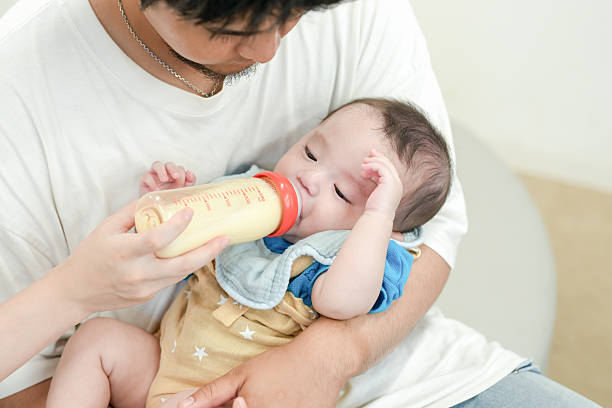 istock A man is feeding a baby with a bottle 2237270836