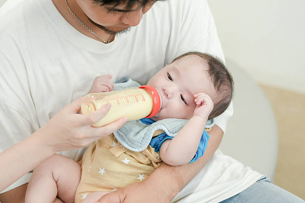 istock A man is feeding a baby with a bottle 2237270960