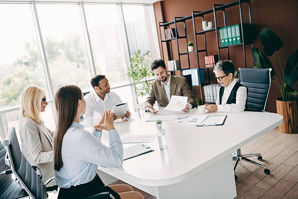 istock Professional team meeting in modern office with diverse group discussing project strategies and collaborating on business development 2237270981