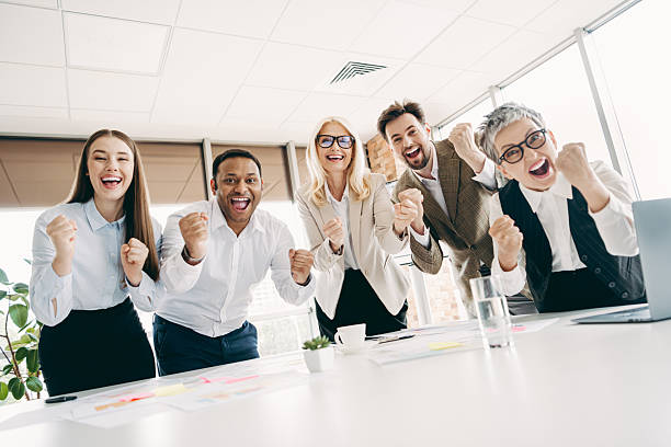 istock Celebrate achievement with a diverse team collaborating at a modern office workspace, reflecting joy and successful teamwork 2237271011
